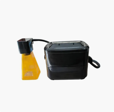 Portable handheld marking and engraving device with a yellow marking head connected to a compact black control unit.