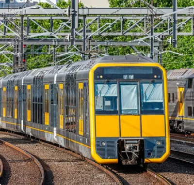 Electric commuter train traveling on electrified railway tracks within an urban rail transit network.