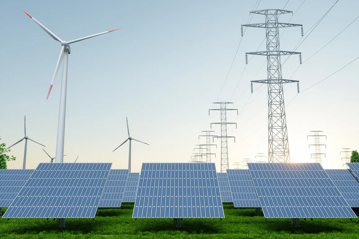 High-voltage power transformer installed at an electrical substation with bushings, cooling radiators, and overhead transmission connections.